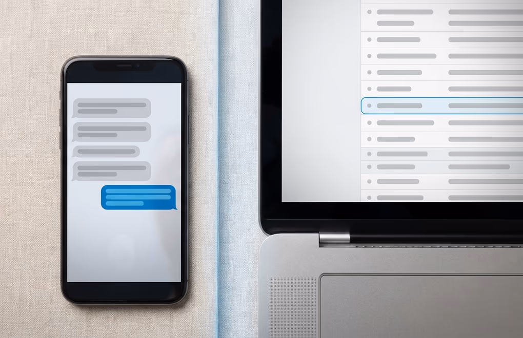 A phone showing a LinkedIn chat beside an email inbox as two outreach channels
