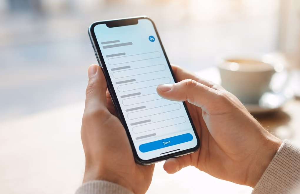 A person adding a credential in the LinkedIn app on a phone