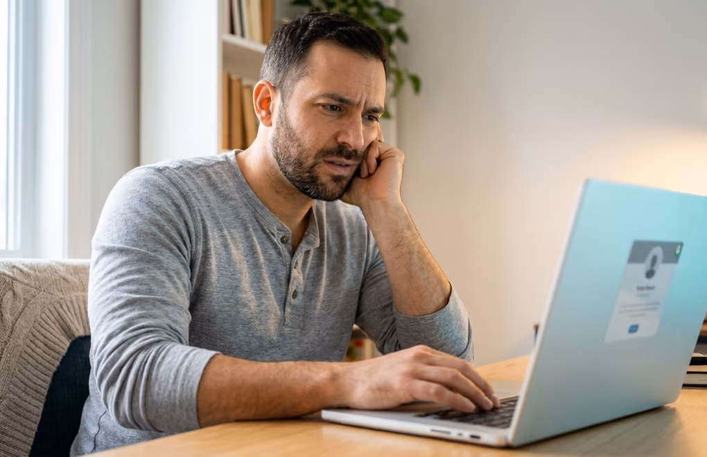 A person checking a profile on a laptop after a job update failed to appear in the feed