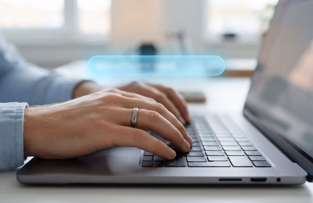 Close-up of hands editing a custom handle in a profile settings field on a laptop