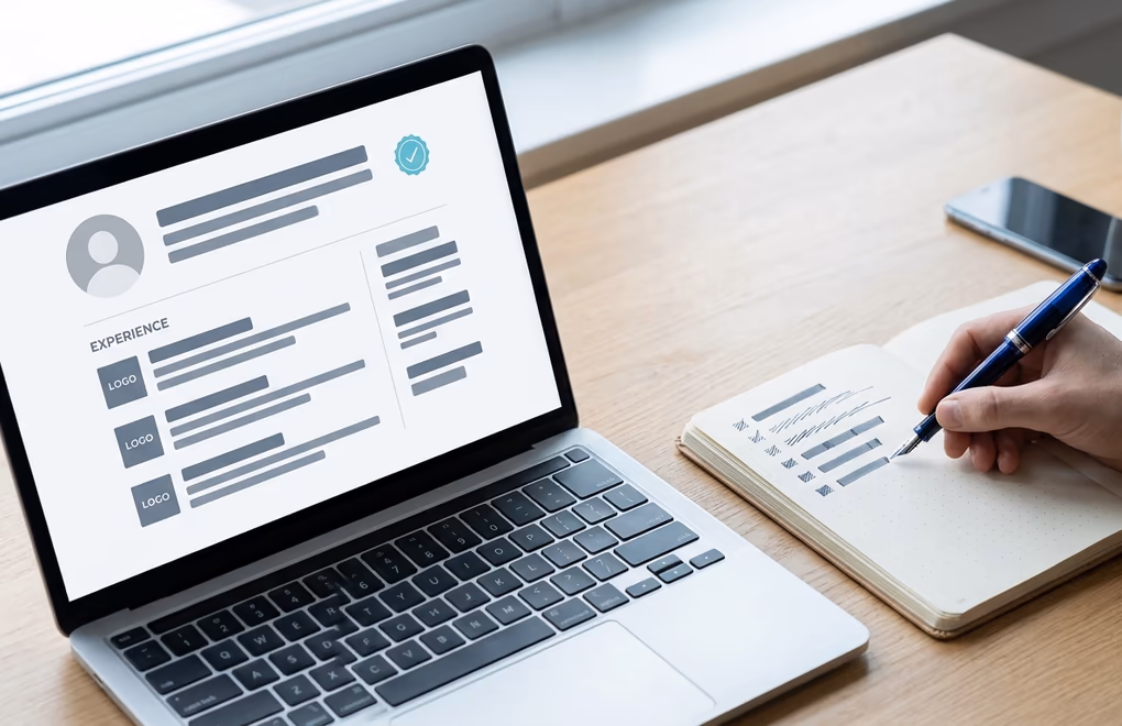 A profile open beside handwritten notes while a seller checks a prospect's authority before messaging