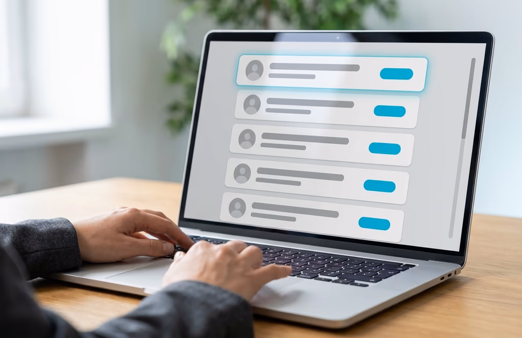 A laptop showing a shortlist of matched LinkedIn prospects with job titles and companies