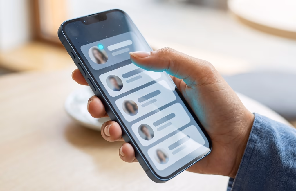 A phone showing a stack of recent visitor cards with small profile photos and a viewer count