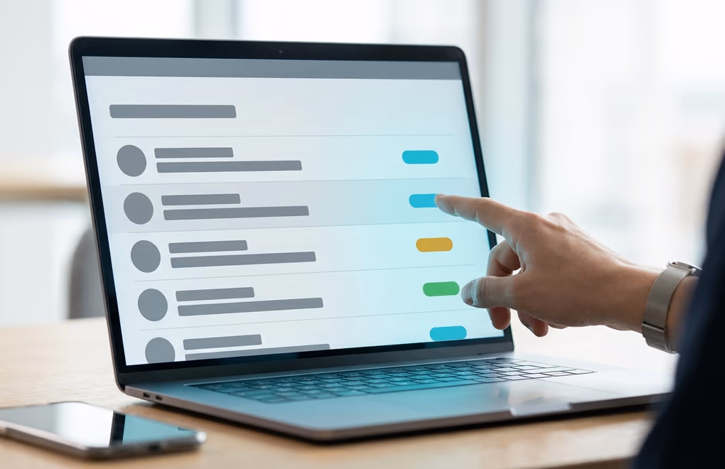 A prospect shortlist on a laptop with recent company events highlighted as buying signals
